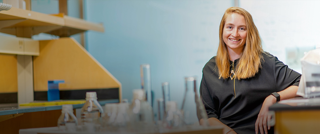 blonde woman scientist sitting in a lab