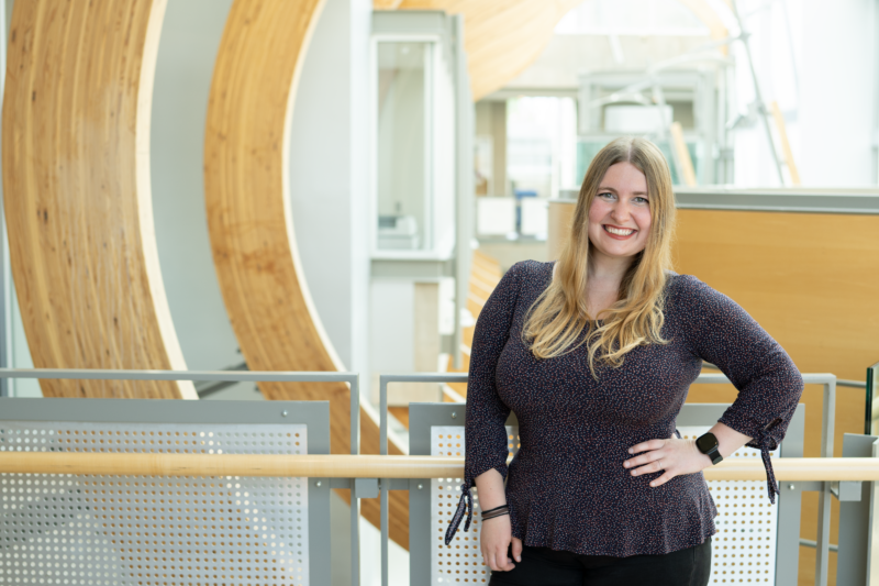 Jefferies lab member and Gilbert award recipient Marie Johns smiles to camera from inside the Michael Smith Laboratories building.